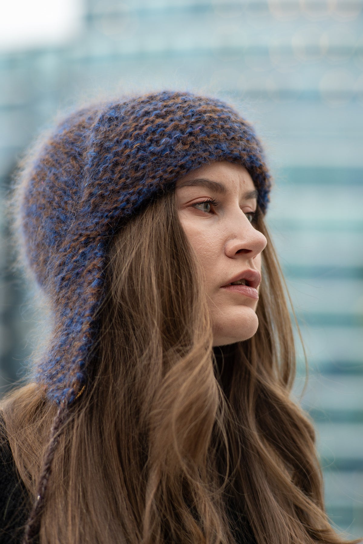 Warm hat with ear flaps and pompoms in blue and brown heathered yarn – The Arctic Cap from CosyMonday